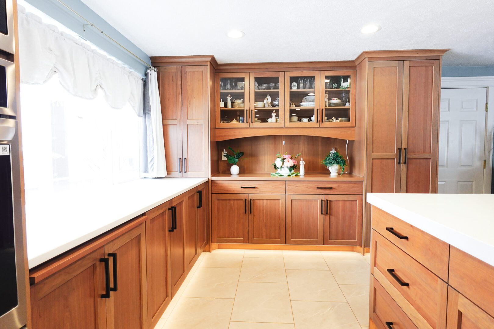 Sunlit Cache Valley kitchen with natural wood cabinets and island