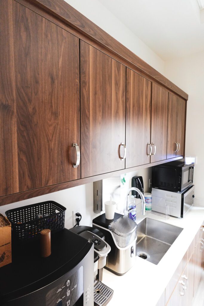 Modern kitchenette with walnut cabinets and sink