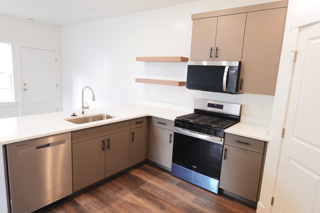 Bright L-shaped kitchen with stainless appliances