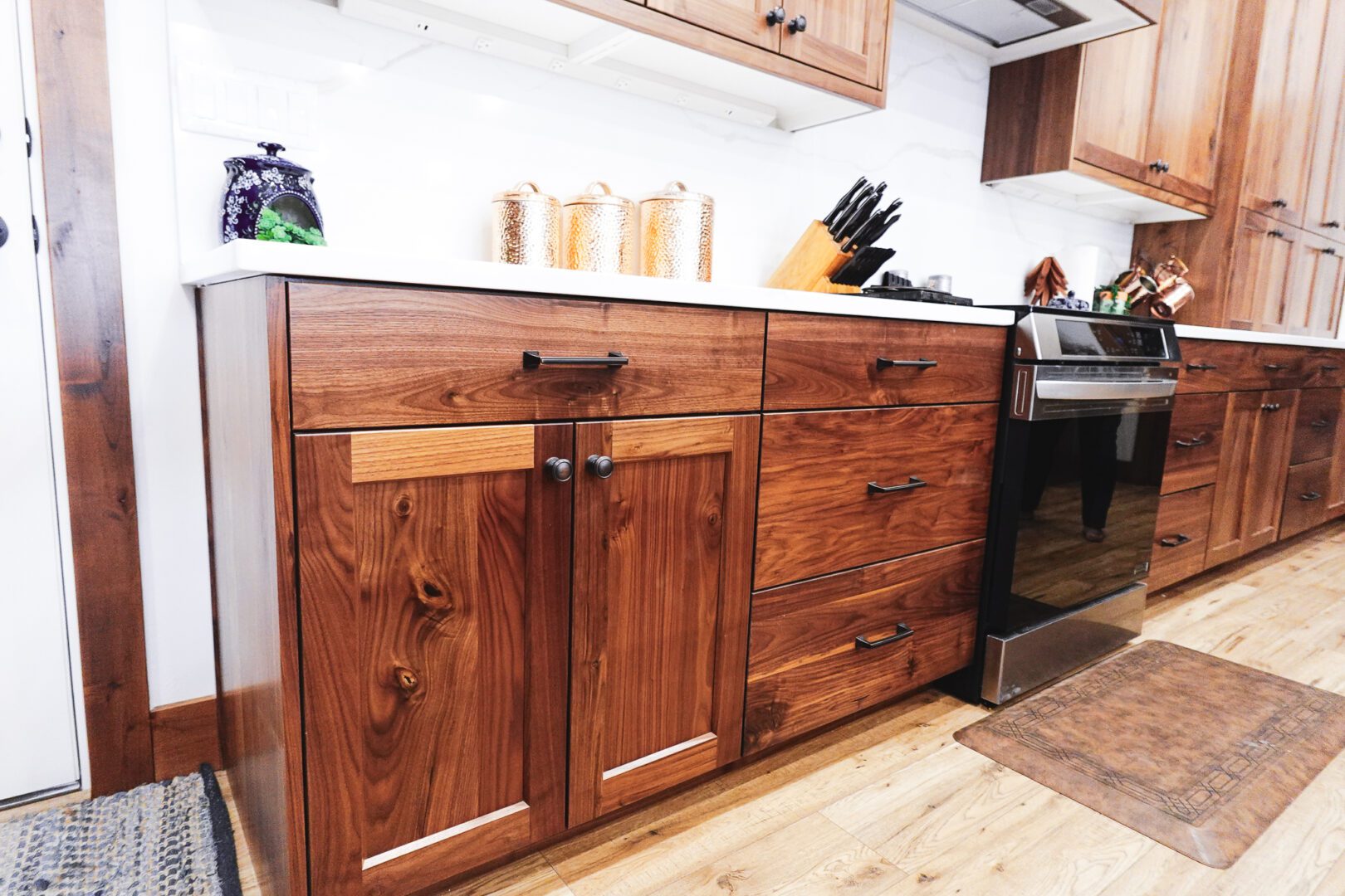 Walnut kitchen cabinets with stainless stove