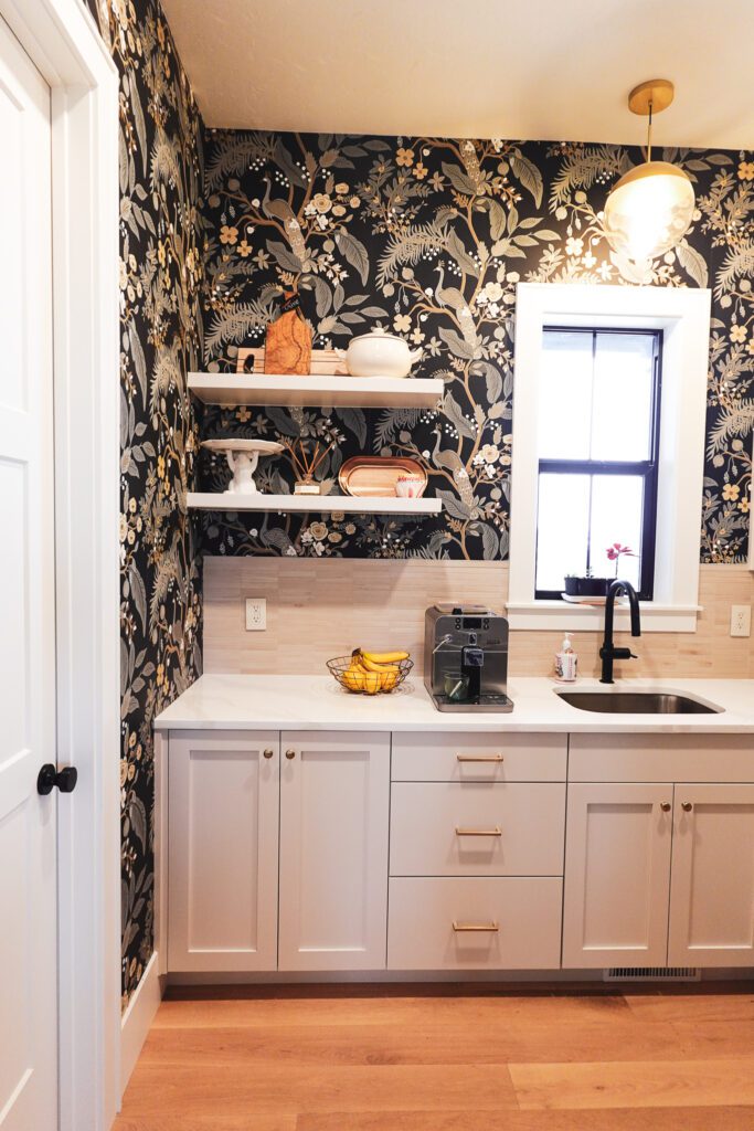 Single-wall wet bar with bar sink, Shaker drawers, and floating shelves built by Rivermill for a Smithfield home, a layout ideal for basement wet bar cabinets in Cache Valley