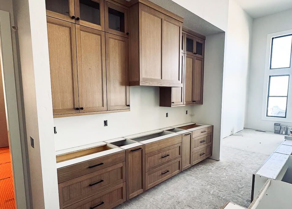 Unfinished kitchen with newly installed wooden cabinets